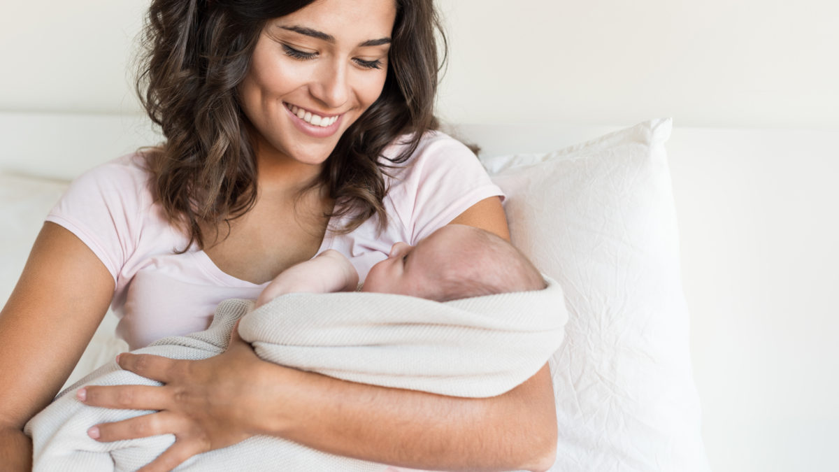 Woman carrying her newborn