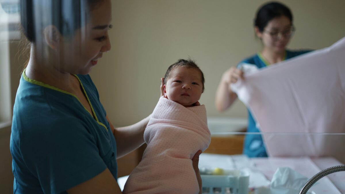 a midwife holding a newborn