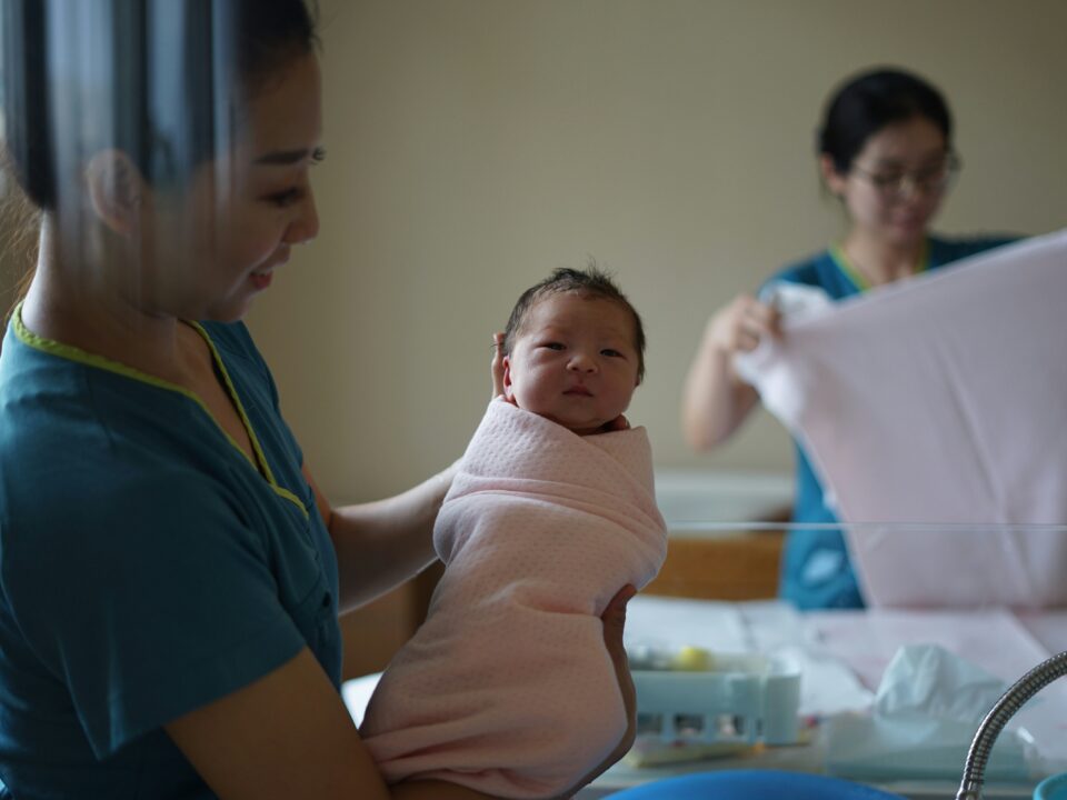 a midwife holding a newborn