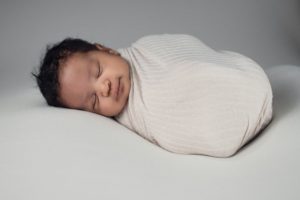 Newborn baby swaddled after a home birth