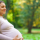 Pregnant woman sitting on park bench