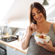 Woman managing pregnancy cravings by eating fruit