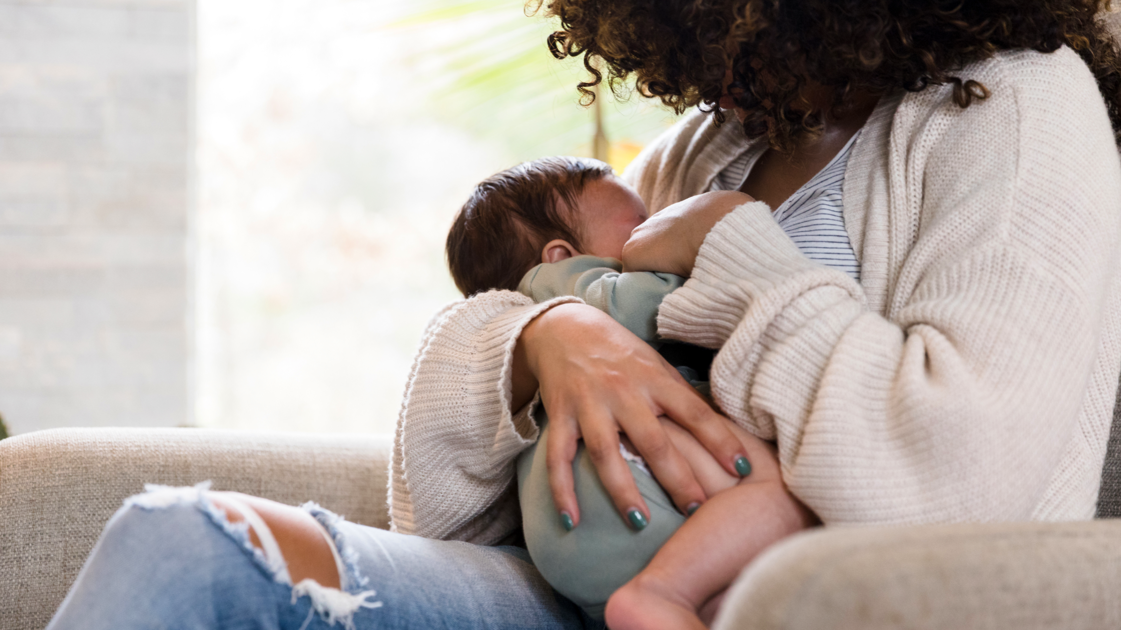 Lactating mother breastfeeds her child