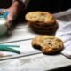 a stack of cookies next to a glass of milk