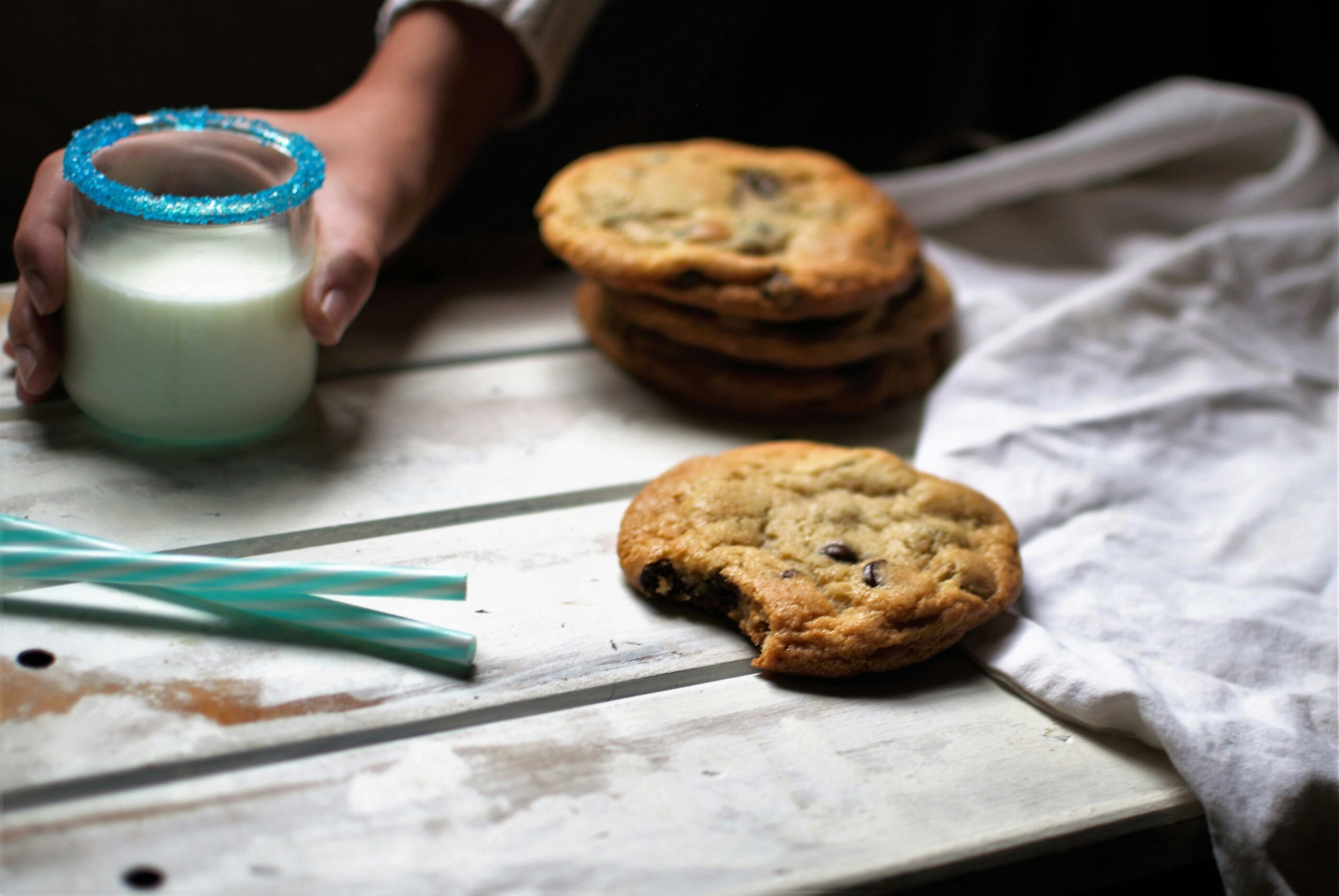 a stack of cookies next to a glass of milk