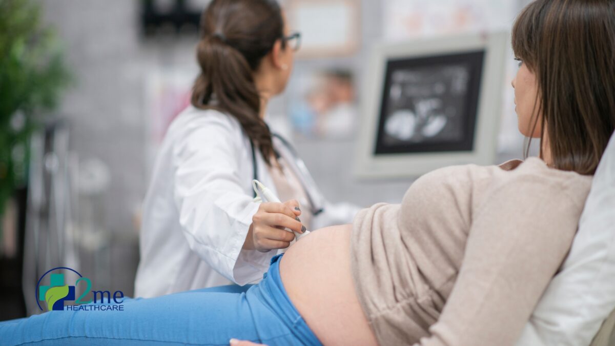 a pregnant woman getting an ultrasound from her obgyn
