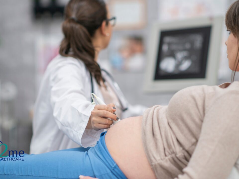 a pregnant woman getting an ultrasound from her obgyn